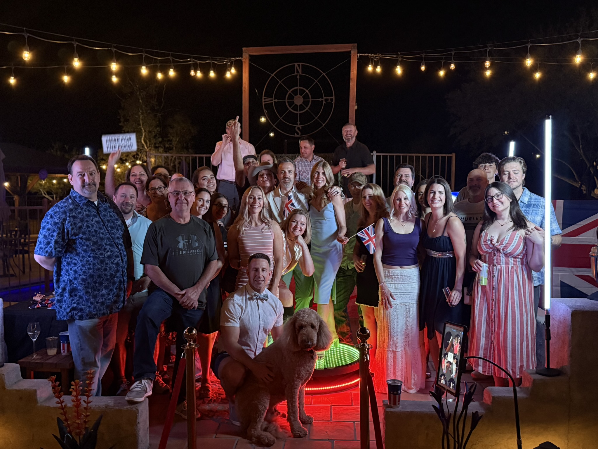 Large corporate group photo at outdoor British themed activation with LED poles and red carpet, Tucson AZ